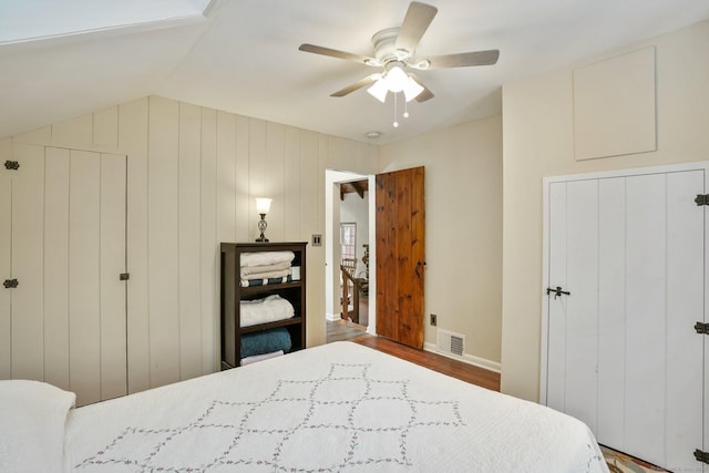 bedroom featuring wood-type flooring, ceiling fan, and vaulted ceiling