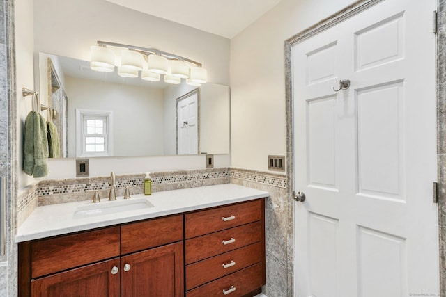 bathroom with vanity and tile walls