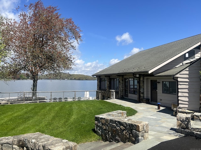 view of yard featuring a water view and a patio