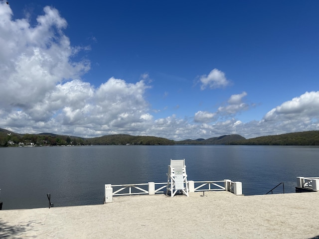 view of dock with a water and mountain view