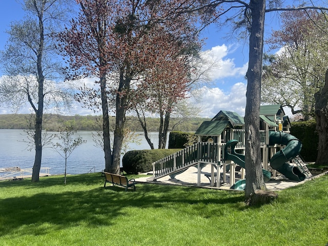 view of yard with a playground and a water view