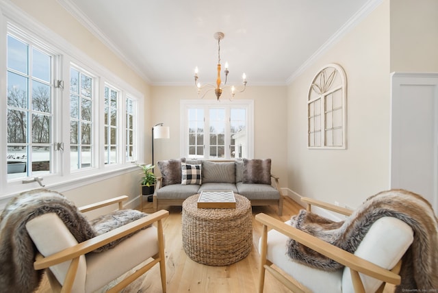 sitting room featuring baseboards, crown molding, a chandelier, and wood finished floors