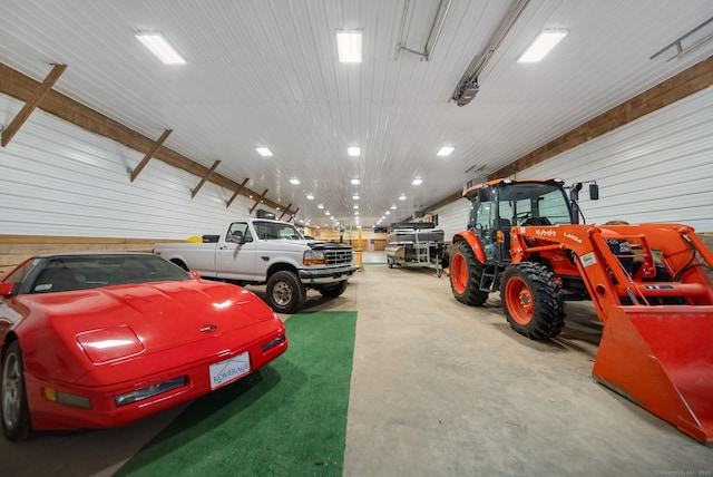 garage with a garage door opener and metal wall