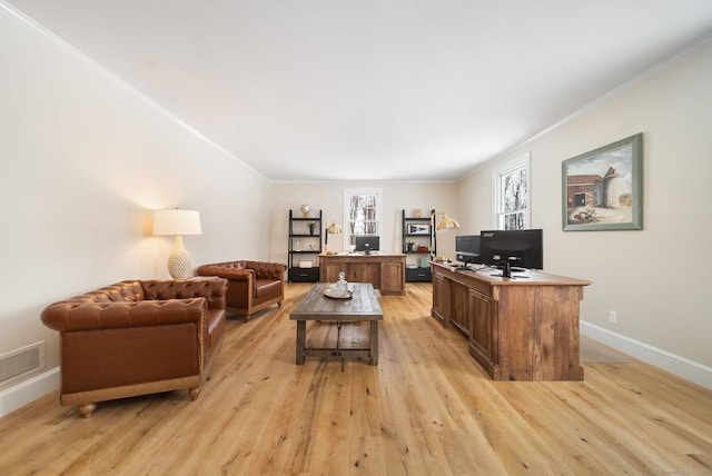 living area with ornamental molding, light wood finished floors, and visible vents