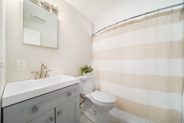 full bathroom featuring toilet, visible vents, and vanity