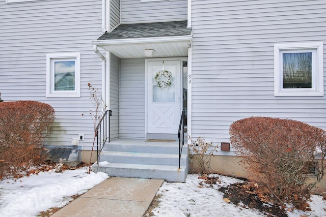 view of snow covered property entrance