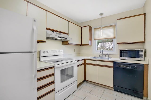 kitchen with hanging light fixtures, light tile patterned flooring, sink, and white appliances