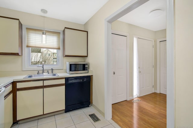 kitchen featuring pendant lighting, light hardwood / wood-style floors, dishwasher, and sink