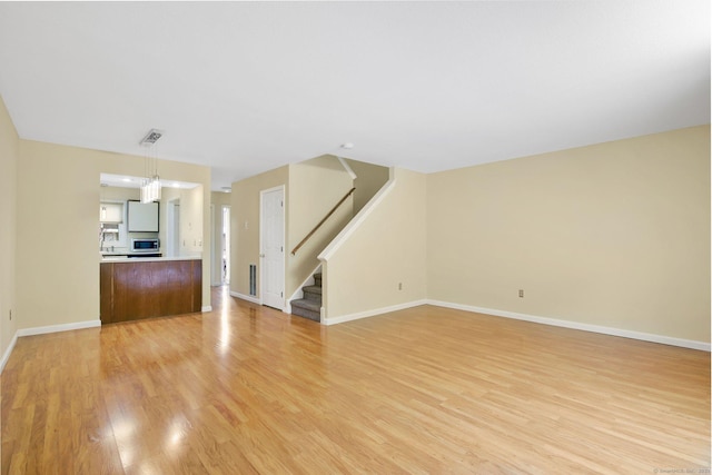 unfurnished living room featuring light hardwood / wood-style flooring