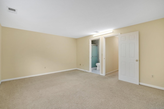 spare room featuring light carpet