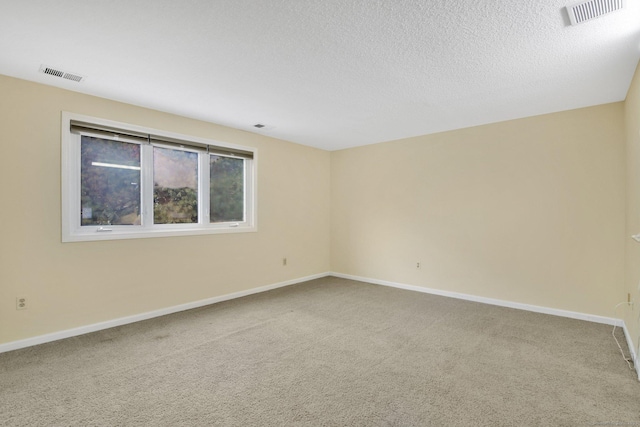 empty room featuring carpet flooring and a textured ceiling