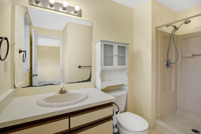 bathroom featuring vanity, toilet, and walk in shower