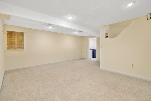 unfurnished room featuring light carpet