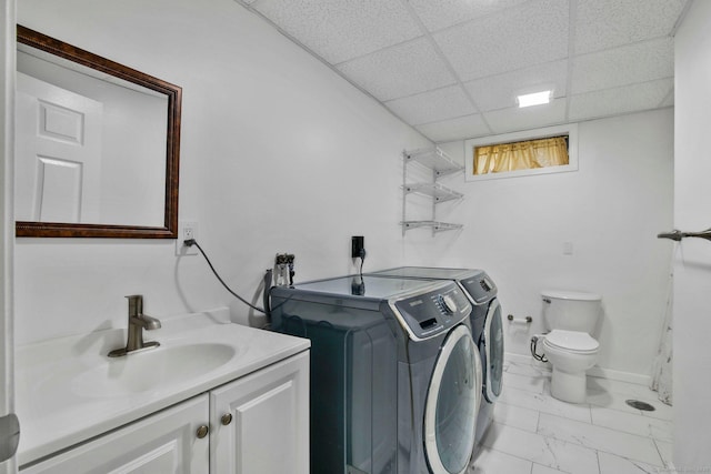 clothes washing area featuring sink and independent washer and dryer