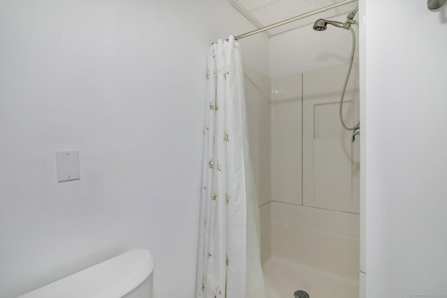 bathroom with toilet and walk in shower