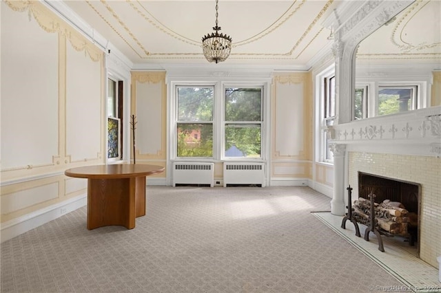 interior space with radiator heating unit, a tile fireplace, and a notable chandelier