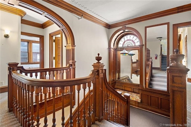 interior space with ornamental molding and carpet flooring