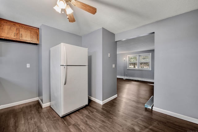 kitchen with dark hardwood / wood-style floors, white refrigerator, ceiling fan, baseboard heating, and a textured ceiling