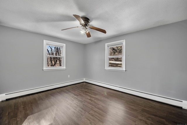 unfurnished room featuring a baseboard radiator, a healthy amount of sunlight, hardwood / wood-style floors, and a textured ceiling