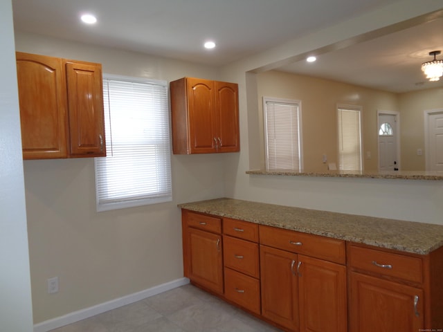 kitchen featuring light stone counters and kitchen peninsula