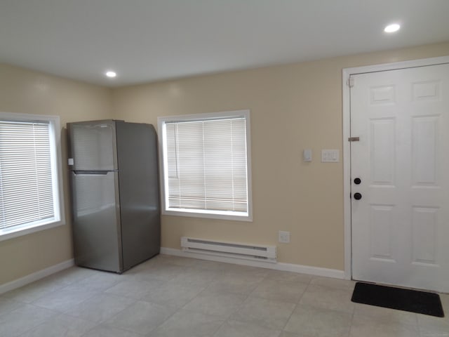 interior space featuring light tile patterned floors and baseboard heating