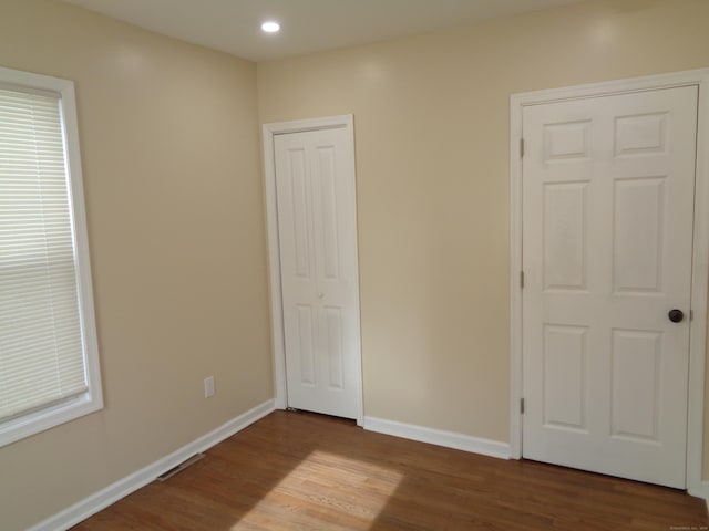 unfurnished bedroom with wood-type flooring