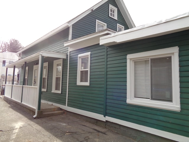 view of side of home with a porch