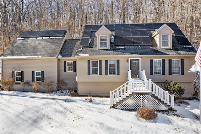 cape cod-style house with solar panels