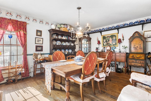 dining room featuring hardwood / wood-style floors and a chandelier