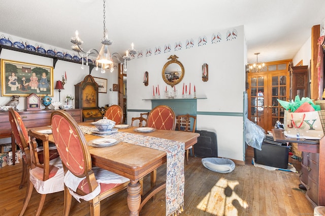 dining room featuring hardwood / wood-style floors, a notable chandelier, and french doors