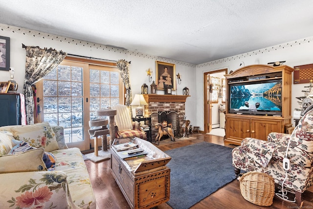 living room featuring a textured ceiling, dark hardwood / wood-style flooring, and a fireplace