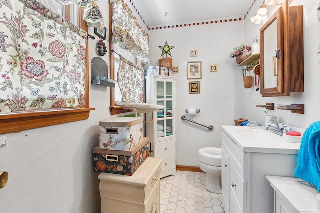 bathroom featuring tile patterned flooring, vanity, and toilet