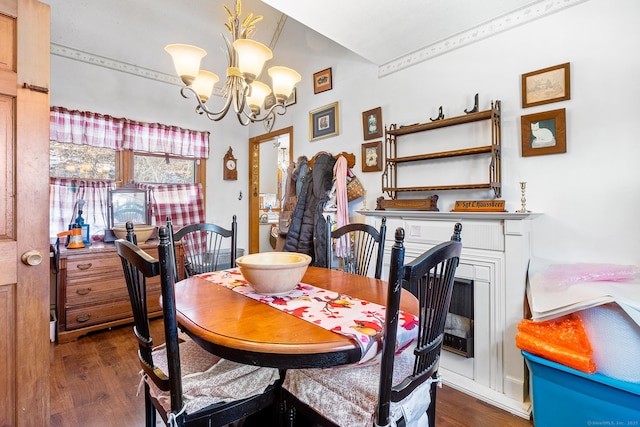 dining room with dark wood-type flooring and a chandelier