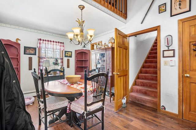 dining space with dark wood-type flooring, a chandelier, and baseboard heating