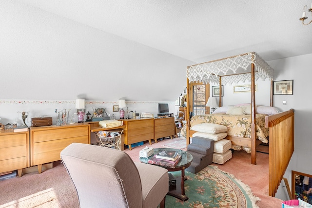 carpeted bedroom featuring vaulted ceiling and a textured ceiling