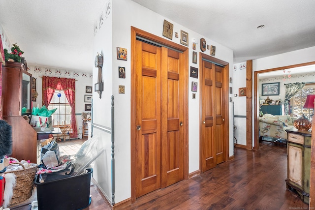 interior space with dark hardwood / wood-style floors and a textured ceiling