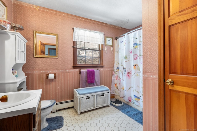 bathroom featuring baseboard heating, vanity, toilet, and walk in shower