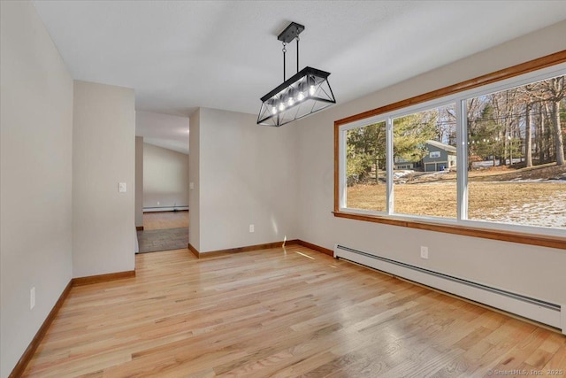 unfurnished dining area with a baseboard radiator, a chandelier, and light wood-type flooring