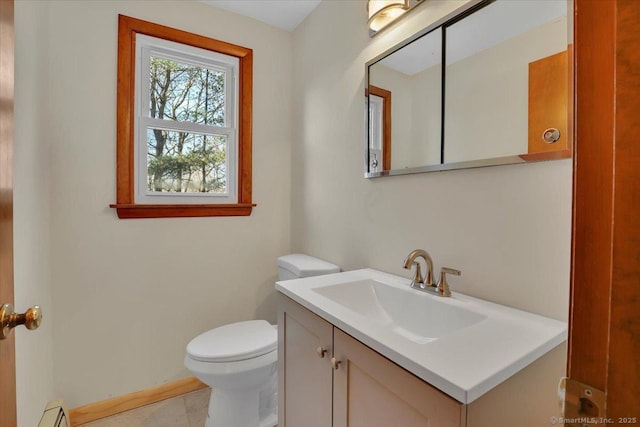 bathroom with vanity, a baseboard heating unit, and toilet