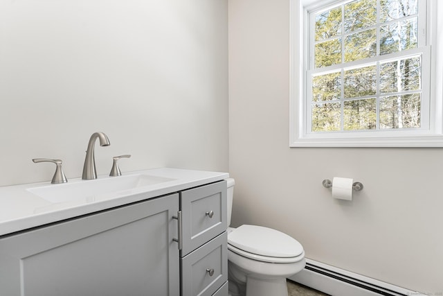 bathroom with toilet, baseboard heating, and vanity