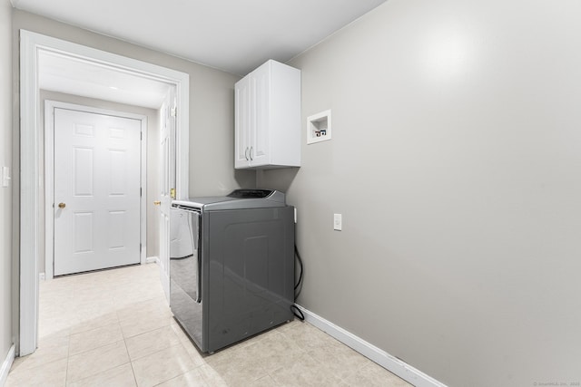 laundry room with washer / dryer, cabinet space, and baseboards