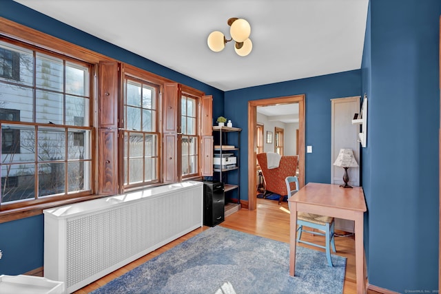 office space with radiator and light hardwood / wood-style floors