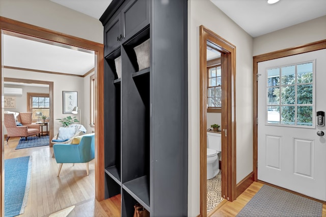 mudroom with a wall mounted AC and hardwood / wood-style floors