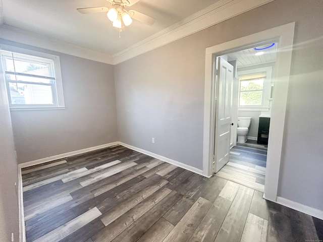 spare room with crown molding, dark hardwood / wood-style floors, and ceiling fan