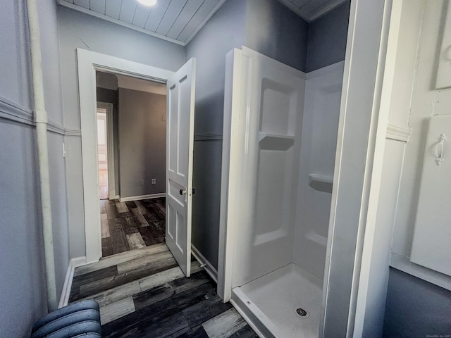 bathroom with hardwood / wood-style flooring and a shower