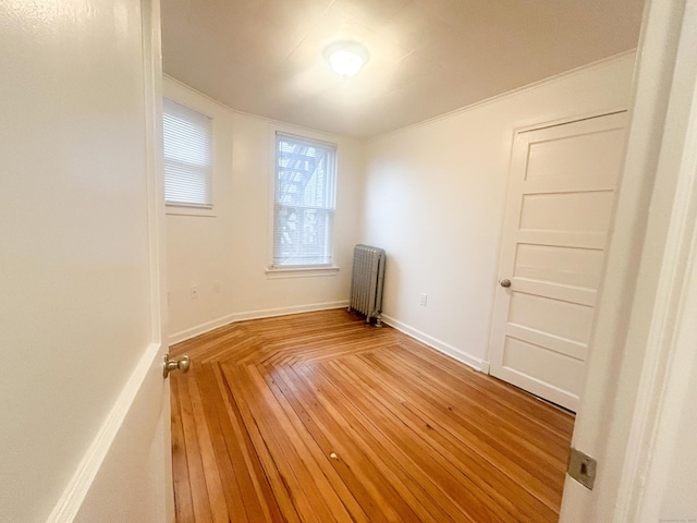 empty room featuring parquet floors and radiator