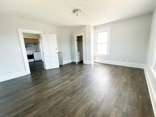 unfurnished bedroom featuring dark hardwood / wood-style floors