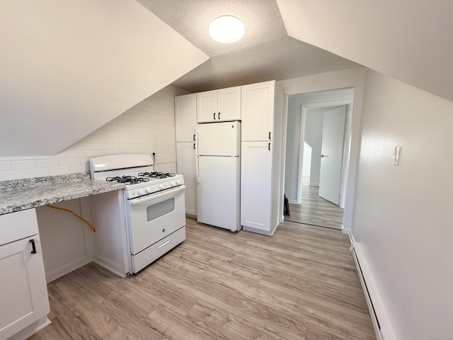 kitchen featuring lofted ceiling, white appliances, white cabinetry, light hardwood / wood-style floors, and decorative backsplash