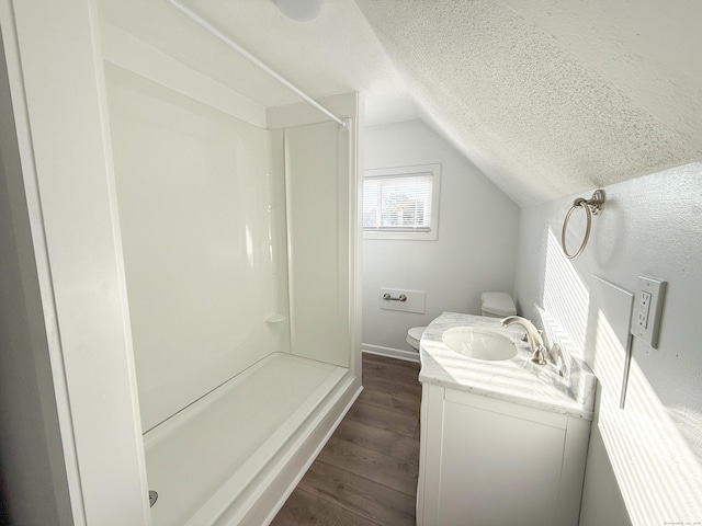 bathroom with vanity, wood-type flooring, toilet, and walk in shower