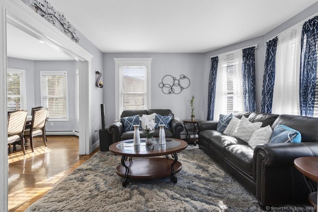 living room featuring hardwood / wood-style flooring and baseboard heating